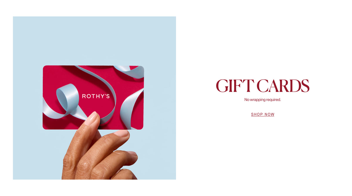 A hand holds a Rothy's gift card with a pink and white ribbon design against a light blue background on the left, while the right side features the text 'GIFT CARDS' and 'SHOP NOW' on a white background.