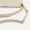 A closeup of The Daily Crossbody Bag in White Sand, showing the smooth zipper closure and soft, flexible handle.
