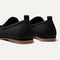 Close up of the heel of The Ravello Loafer in Stone Black, with Rothy's signature blue halo on the pull tab.