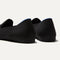Close up of the heel of The Almond Loafer in Black, with Rothy's signature blue halo. 