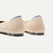 Close up of the heel of The Point II in Ecru, with Rothy's signature blue halo. 