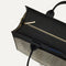 The Classic Tote in Black Herringbone, shown from above, with the top zipper closed. 