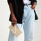hover | The Wallet Wristlet in Vanilla Basketweave, held by a model, shown from the front.
