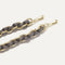 A close-up of The Shoulder Strap in Golden Silver Chain, focusing on the end snap hooks. 