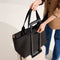 hover | Model holding The Zip Travel Tote in Night Song.