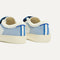 Close up of the heel of The Kids Strap Sneaker in Blue Raspberry, with Rothy's signature blue halo. 