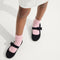 hover | Model wearing The Kids Tux Bow Mary Jane in ReVelvet™ Black.