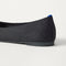 Close up of the heel of The Almond Ballet in Black, with Rothy's signature blue halo. 