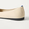 Close up of the heel of The Almond Ballet in Conch Captoe, with Rothy's signature blue halo. 