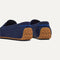 Close up of the heel of The Men's Driver in Nautical Navy, with raised peg outsoles and Rothy's signature blue halo. 