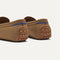 Close up of the heel of The Men's Driver in Oak Herringbone, with raised peg outsoles and Rothy's signature blue halo. 