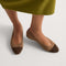 hover | Model wearing The Almond Ballet in ReVelvet Portobello Captoe. 