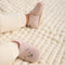 model | Model wearing The Baby Moc in Blush Teddy.