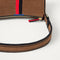 A closeup of The Casual Crossbody in ReVelvet Cinnamon Stripe, focusing on the crossbody strap. 